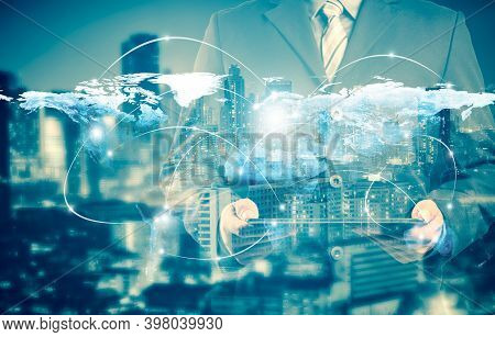 Double Exposure Of Success Businessman Using Digital Tablet With City Landscape Background.connectio