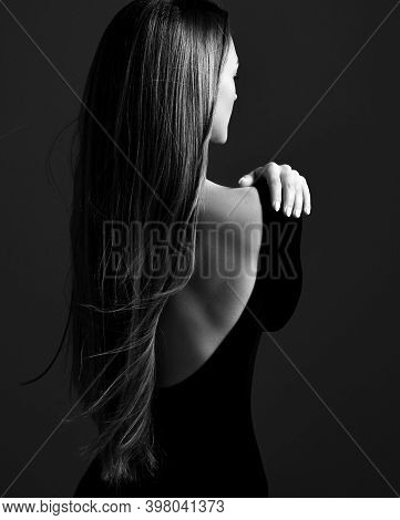 Young Pretty Woman Model Standing Backwards In Dress With Open Back And Showing Her Gorgeous Silky L