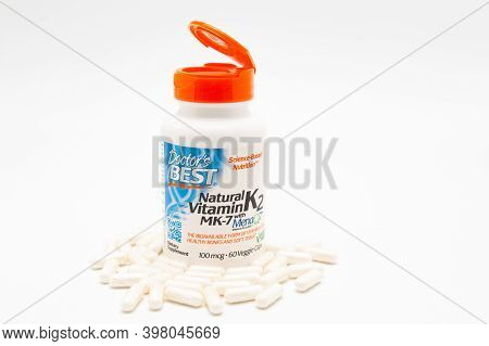 Fuji City, Shizuoka-Ken, Japan - November 7, 2020: Doctors Best, Natural Vitamin K2 MK-7 with MenaQ7, 100 mcg, 60 Veggie Caps. Scattered pills. Isolated on white background. Copy space.