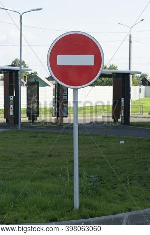 No-entry Road Sign. Red Round Sign On A Pillar With White Bricks.