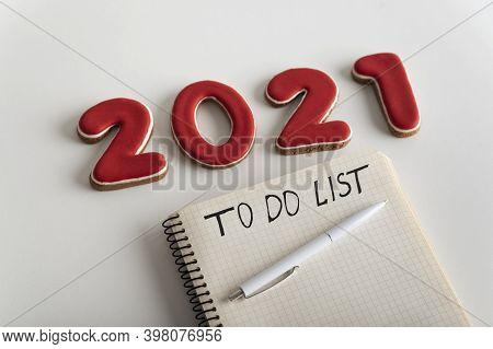 Notepad With Inscription To Do List Pen And Numbers 2021 On White Background Close Up. Plans And Goa