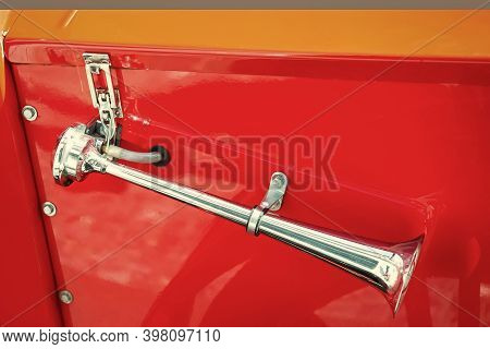 Attention Please. Metal Horn On Red Car Background. Retro Vehicle Horn. Car Air Horn Or Klaxon. Vint