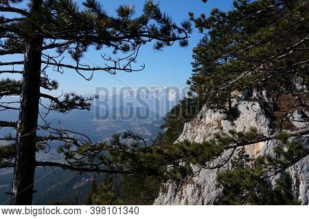 Snowy Mountain Framed By Tree And Rock Face / Alpine Scenery In Austria / Mount Schneeberg / Hohe Wa