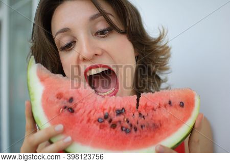 Close Up Indoors Portrait Of Beautiful Woman With Short Hair And Sensual Lips Eating A Piece Of Wate