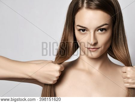 Portrait Of Young Beautiful Woman With Silky Long Straight Hair Looking At Camera And Holding Her St