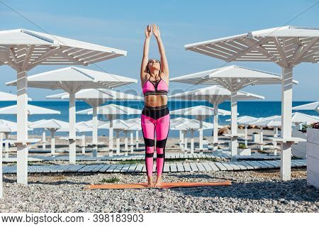 Beautiful Woman Yoga Asana Fitness Flexibility Of Body On The Beach By The Sea