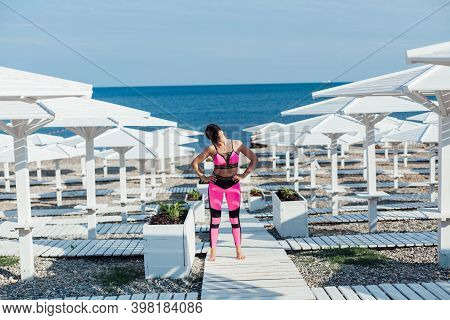 Woman Yoga Asana Fitness Body Flexibility On Beach By The Sea