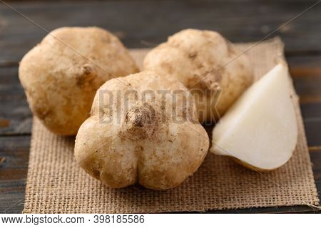 Fresh Jicama Or Yam On Wooden Table, Jicama Can Be Eaten Raw Or Cooked, The Taste Are Crisp, Juicy, 