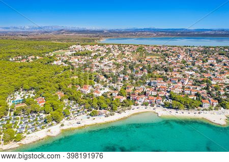 Town Of Pakostane On Adriatic Sea Coast In Croatia And Vransko Lake In Background, Aerial View