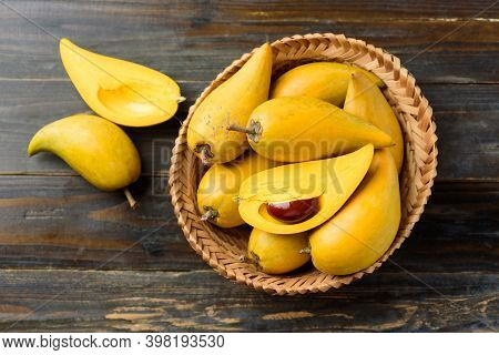 Eggfruit Or Canistel In A Basket On Wooden Table, Thai Fruit, In Thai Names Such As Xiantao, Lamut K
