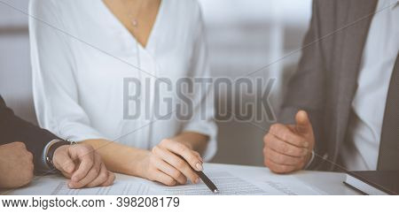Elderly Businessman And Group Of Business People Discussing Contract In Office. Woman And Lawyers Wo