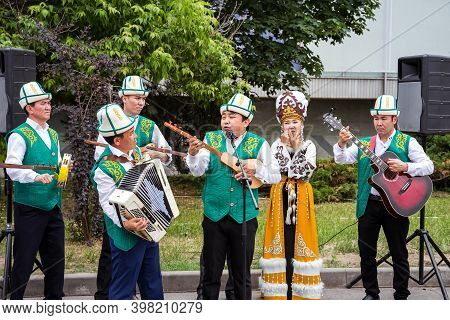 Moscow, Russia, June 12,2019: An Ensemble Of Kyrgyz Musicians In National Dress Plays Folk Instrumen