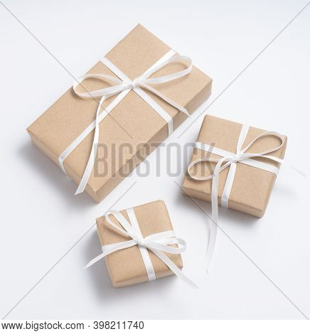 Brown Gift Box Tied With White Ribbon On Clear Background, Copy Space, Eco-friendly Present Concept
