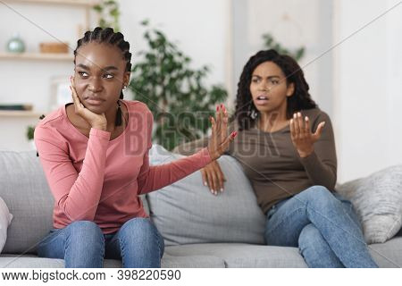 Annoyed Black Woman Showing Stop Gesture To Her Scolding Girlfriend. Two African American Women Girl