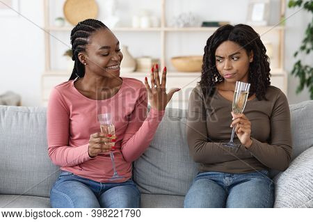 Happy Black Woman Showing Her Upset And Jealous Girlfriend Engagement Ring. Annoyed African American