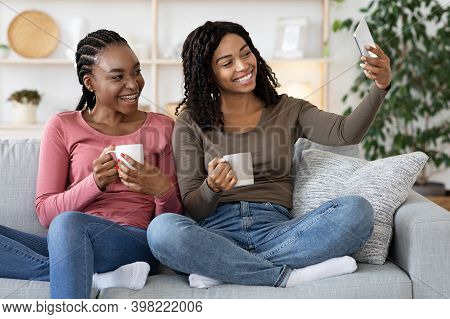 Joyful Black Women Besties Taking Selfie On Smartphone Together While Drinking Tea At Home, Copy Spa