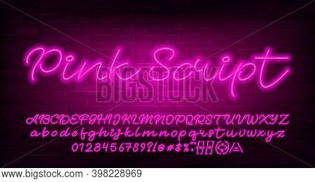 Pink Script Alphabet Font. Pink Neon Light Letters, Numbers And Symbols. Brick Wall Background. Stoc