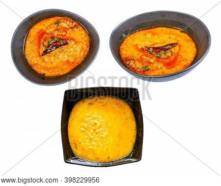 Set Of Dal Tadka (spicy Smooth And Creamy Chowder From Lentils With Curry) In Black Bowl Isolated On
