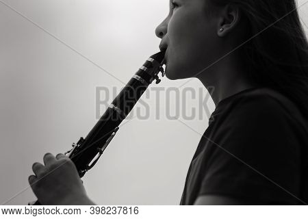 Young Attractive Girl Playing Clarinet, Ebony In Fall Park