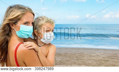 Mother Put Medical Mask On Child On Sea Beach. New Rules To Wear Cloth Face Covering At Public Place