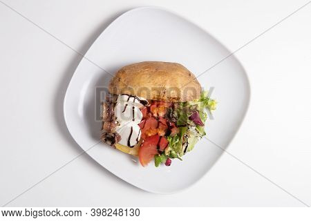 Delicious Stuffed Sweet Potato With Cheese, Anchoa, Tomato And Salad Isolated On A White
