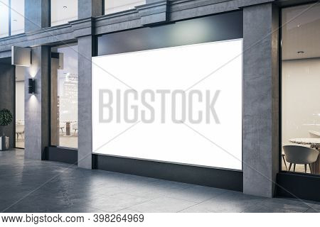Modern Store With Blank Billboard On Vitrine And Concrete Columns. Advertisement And Retail Concept.