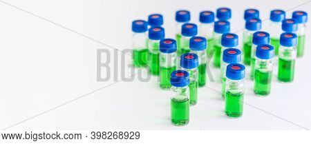 Green Samples In Hplc Vials On The White Background On The White Background With Copy Space. Herbal 