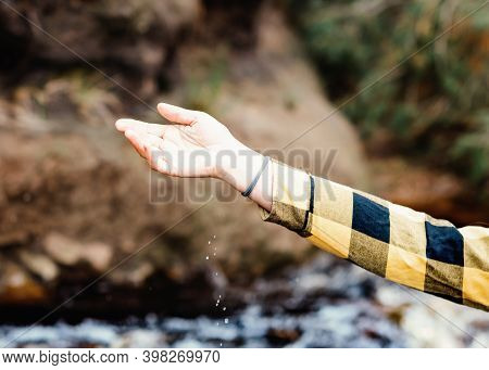 Hand Of Woman In Yellow Shirt Walking In Autumn Forest