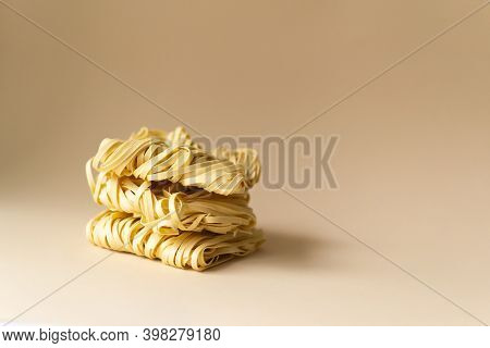 Natural Egg Noodles On A Brown Background. Horizontal Orientation. Copy Space.