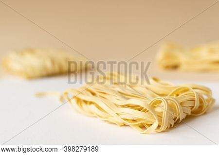 Natural Dry Homemade Noodles On A Brown Background. Horizontal Orientation. Copy Space. Selective Fo