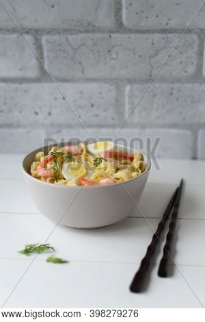 Natural Homemade Noodles With Shrimps And Quail Eggs On A Light Background. Vertical Orientation. Co