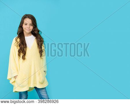Comfy Style. Kid Wearing Soft Poncho. Wellbeing Concept. Little Girl With Long Hair. Happy Childhood