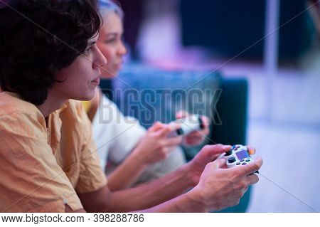 Handsome Young Man Teaching How To Play The Video Games To His Girlfriend, On The Couch, Concept Abo