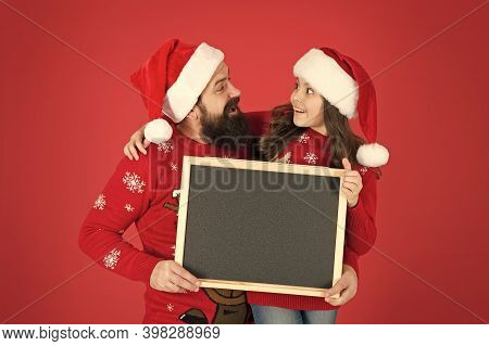 New Year And Christmas Publicity. Happy Family Hold Blank Publicity Board. New Year And Xmas Celebra