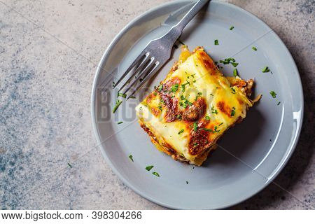 Traditional Greek Potato And Meat Casserole With Cheese - Moussaka, Dark Background. Greek Cuisine C