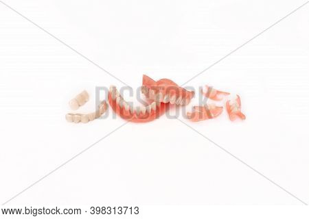 Dentures On A White Background. Close-up Of Dentures. Full Removable Plastic Denture Of The Jaws. Pr