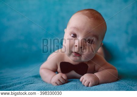 Cute 3 Month Baby Boy On A Blue Blanket.