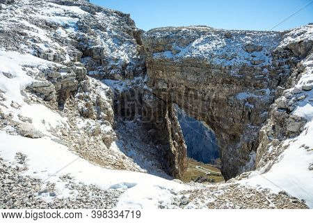  Dolomites in the snow. Arch in the Alps, South Tyrol, Italy. The Pordoi Pass is part of the Dolomiti Superski ski resort. The scenic landscape