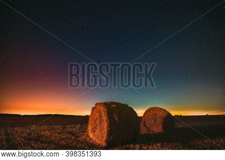 Comet Neowise C2020 F3 In Night Starry Sky Above Haystacks In Summer Agricultural Field. Night Stars