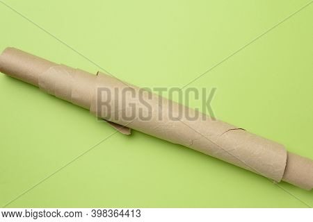 Roll Of Brown Parchment Paper On A Green Background, Top View