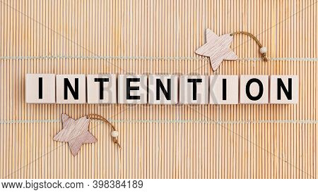 Wooden Cubes With The Abbreviation Intention On Wooden Background