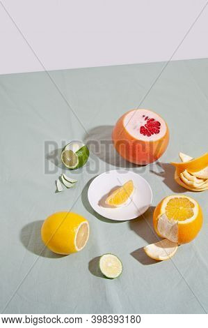 Fruit Citrus With Peels On Green Background. Concept Reducing Food Waste