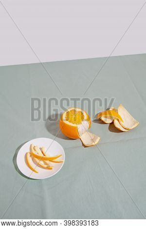 Fruit Orange Citrus With Peels On Green Background. Concept Reducing Food Waste