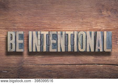 Be Intentional Phrase Combined On Vintage Varnished Wooden Surface