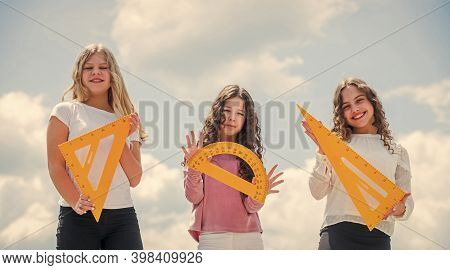 Study Together. Clever Kids. Education Concept. School Students Learning Geometry. Girls With Triang