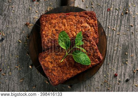 high angle view of some tofu fillets on a gray rustic wooden table