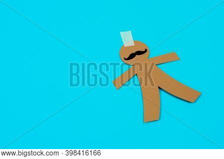 a paper man doll on a blue background, as a prank for the dia de los inocentes, the innocents day, a feast held in spain, hispanic america and philippines equivalent to april fools day