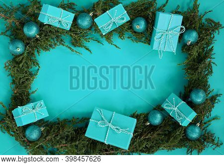 Fflat Lay New Year Christmas Blue Boxes, Blue Balls, Pine Tree On Blue Background. High Quality Phot
