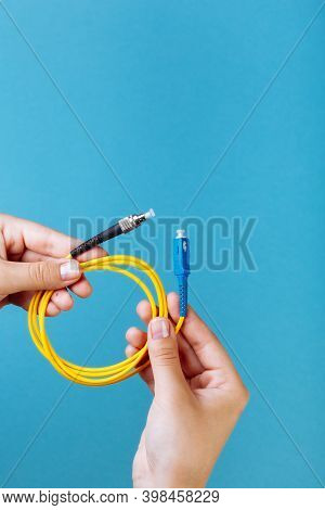 Womans Hands Hold Sc And Fc Connector Fiber Optic Patch Cord Single Mode On Blue Background