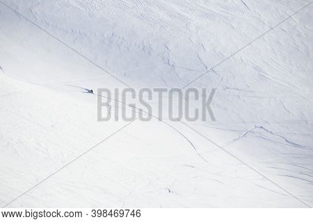 Male Freeride Skier In Northern Mountains In Lapland At Sunny Day Riding Off Piste Far Away View